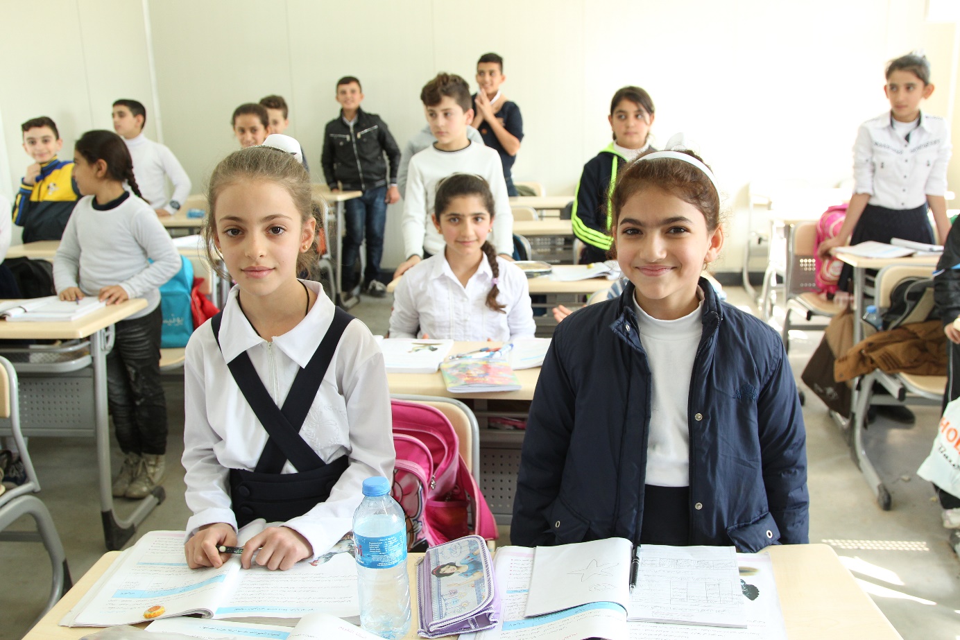 Separated by the flight from ISIS, friends Myriam and Sandra are reunited at a school in Erbil.